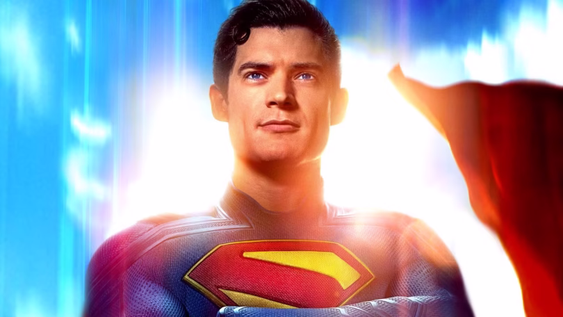 david corenswet s kal el crosses his arms looking up to the bright blue sky in james gunn s superman