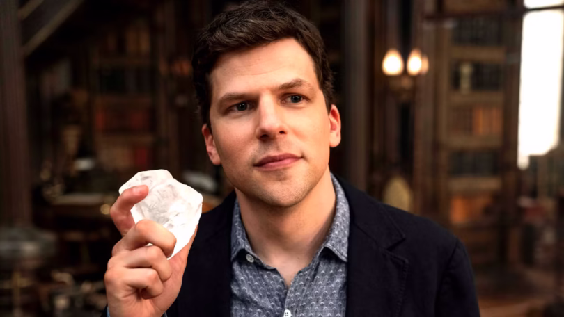 jesse eisenberg as j daniel atlas with a slight smile holding the heart diamond in now you see me no