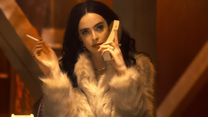 krysten ritter as goldie looking glibly while smoking a cigarette and on the phone in stone cold fox