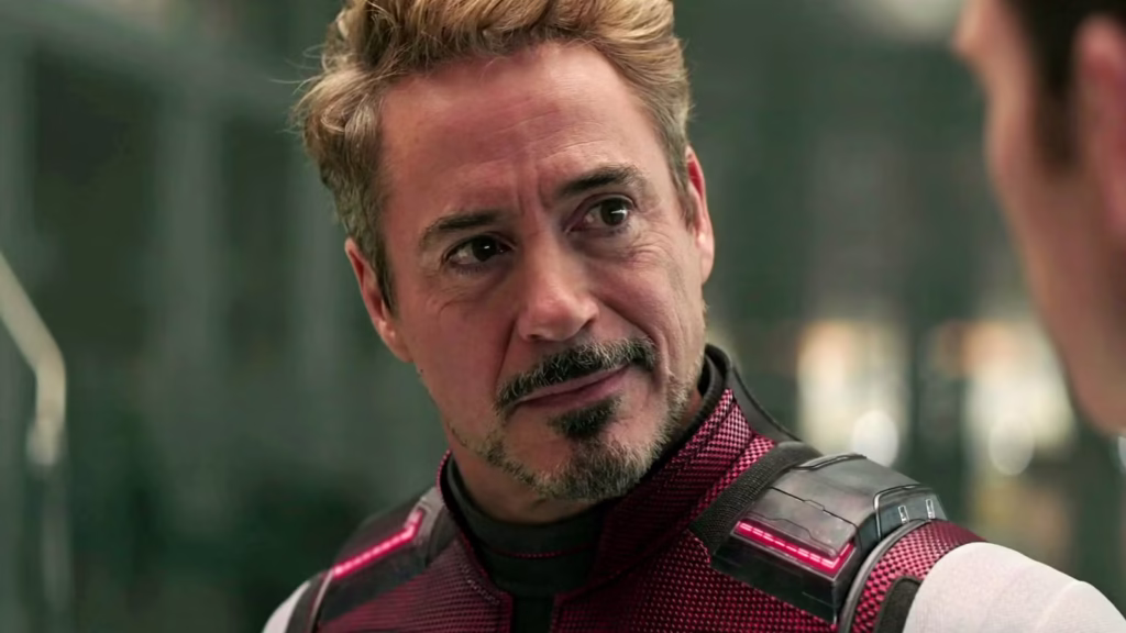 robert downey jr s iron man unmasked and smirking at chris evans captain america in avengers endgame